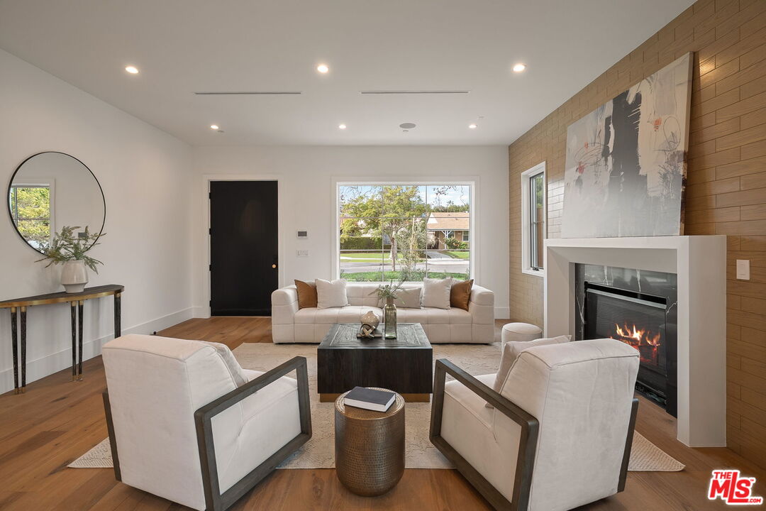 1742 Preuss Road Los Angeles, CA 90035 - Photo 4 of 50 a living room with furniture a fireplace and a large window