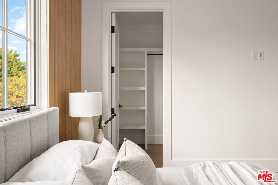 1742 Preuss Road Los Angeles, CA 90035 - Photo 41 of 50 a view of a bedroom with a bed and a table in it