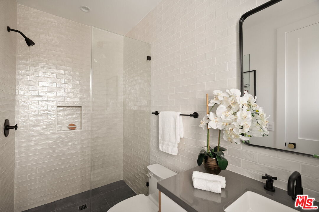 1742 Preuss Road Los Angeles, CA 90035 - Photo 42 of 50 a bathroom with a sink mirror toilet and shower