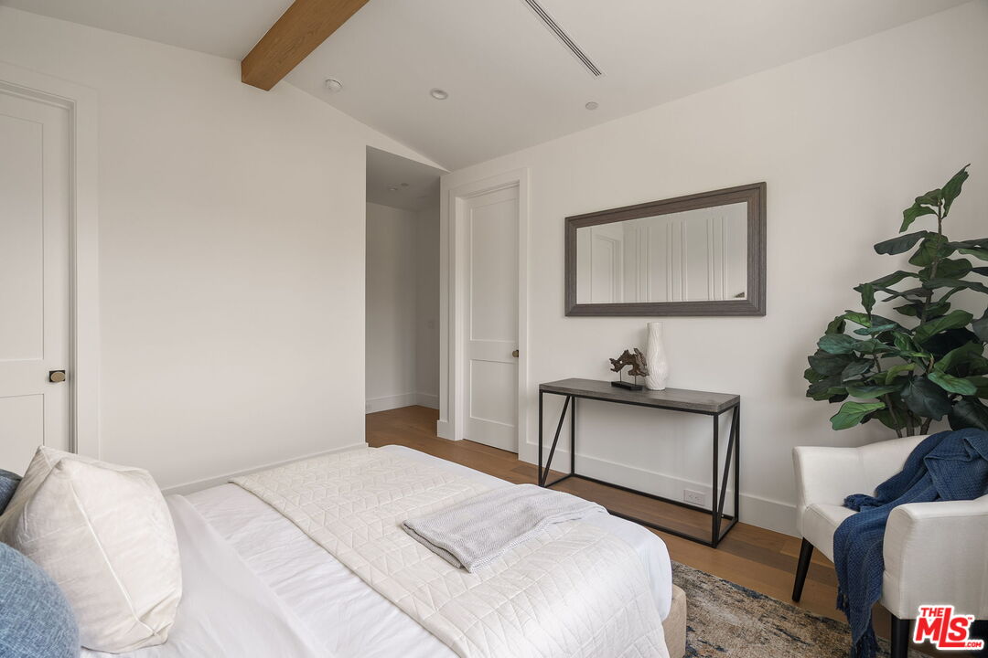 1742 Preuss Road Los Angeles, CA 90035 - Photo 44 of 50 a bedroom with a bed and a potted plant