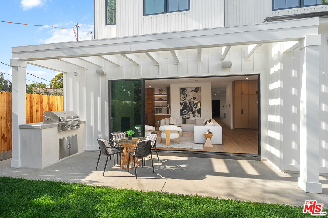 1742 Preuss Road Los Angeles, CA 90035 - Photo 50 of 50 a living room with a rug table and a large window