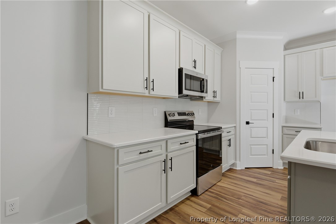 3931 Hamilton Street Hope Mills, NC 28348 - Photo 21 of 50 a kitchen with white cabinets and white appliances