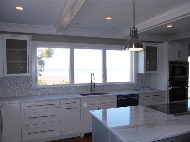 225 Sparrow Road Eastham, MA 02642 - Photo 19 of 29 a kitchen with granite countertop kitchen island white cabinets and stainless steel appliances