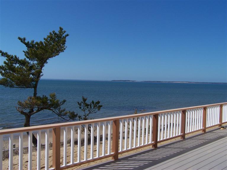 225 Sparrow Road Eastham, MA 02642 - Photo 2 of 29 a view of balcony with wooden floor and seating space