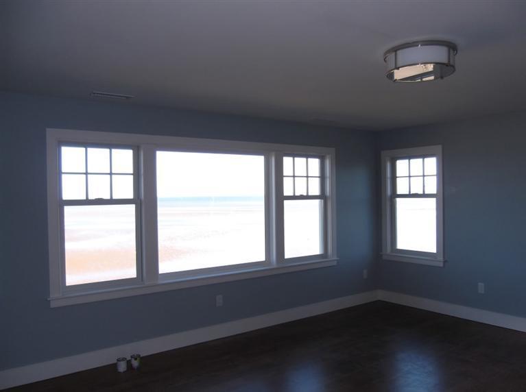 225 Sparrow Road Eastham, MA 02642 - Photo 26 of 29 an empty room with wooden floor and windows