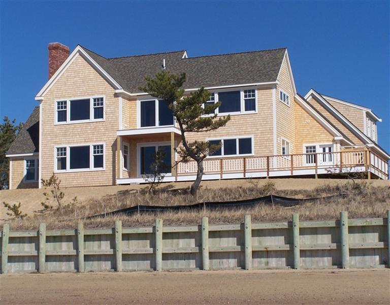 225 Sparrow Road Eastham, MA 02642 - Photo 3 of 29 a view of a white house with large windows