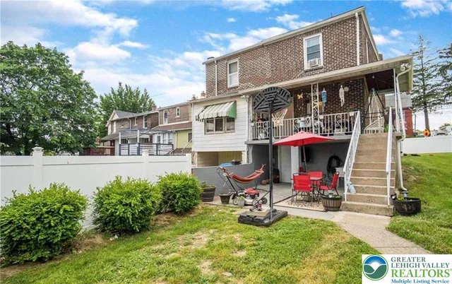 a view of a house with sitting area and garden