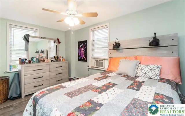 a bedroom with a bed and a dresser in it