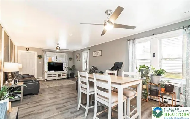 a view of a dining room with furniture window and wooden floor