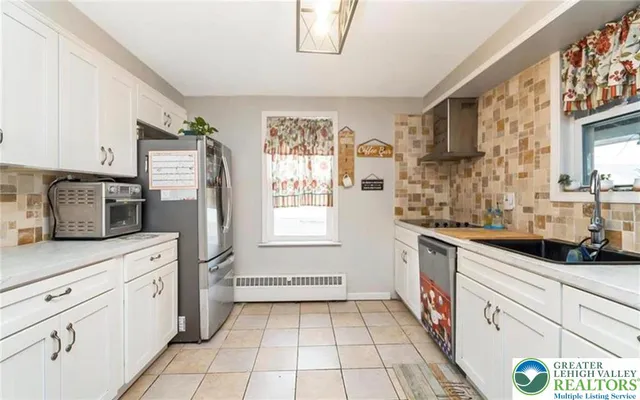 a kitchen with granite countertop a sink stove and cabinets