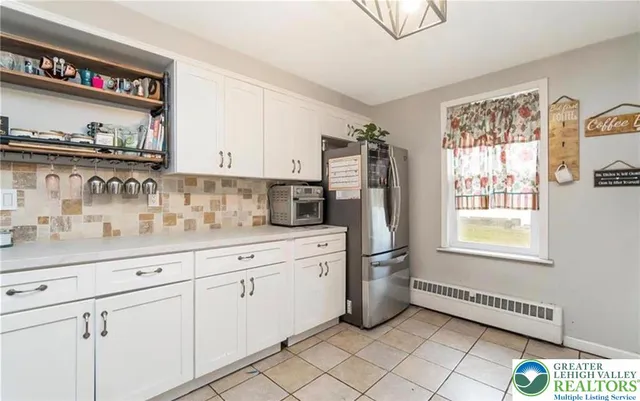 a kitchen with stainless steel appliances a sink and a refrigerator
