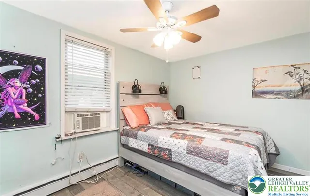 a bedroom with a bed and a chandelier