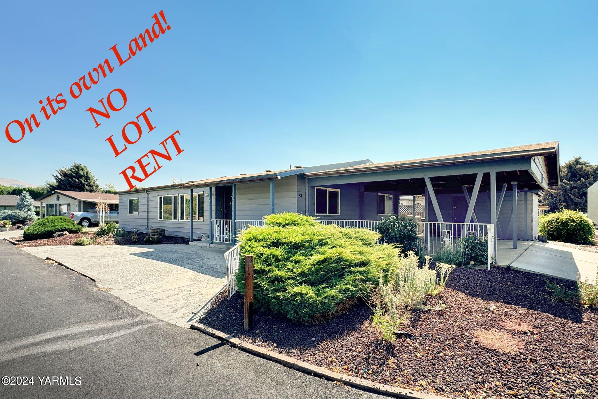 3701 Gun Club Road, Unit 54 Yakima, WA 98901 - Photo 1 of 17 a front view of a house with garden
