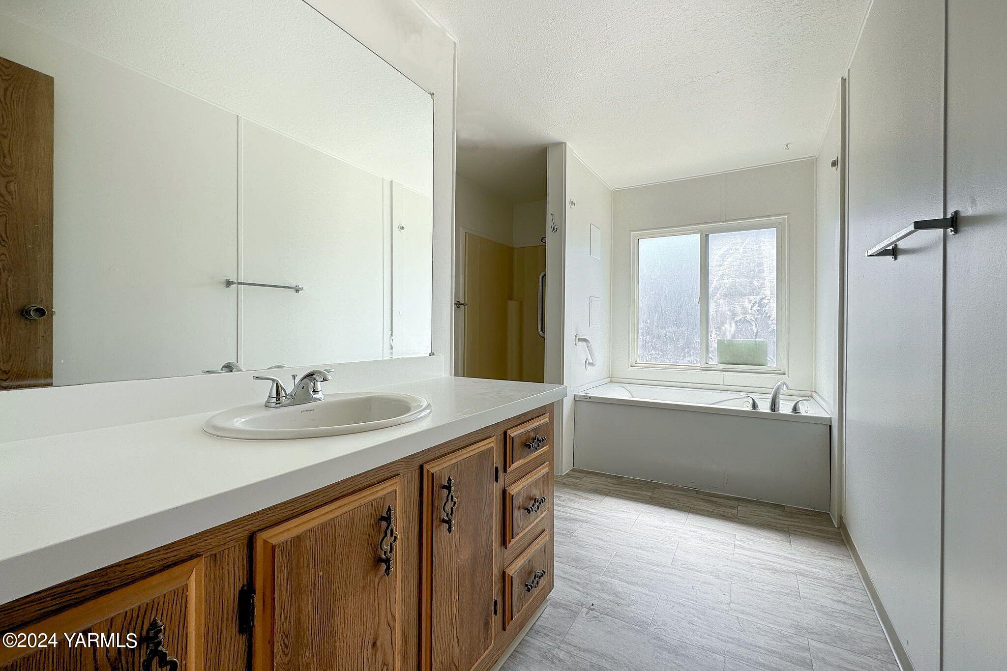 3701 Gun Club Road, Unit 54 Yakima, WA 98901 - Photo 15 of 17 a bathroom with a sink and a mirror