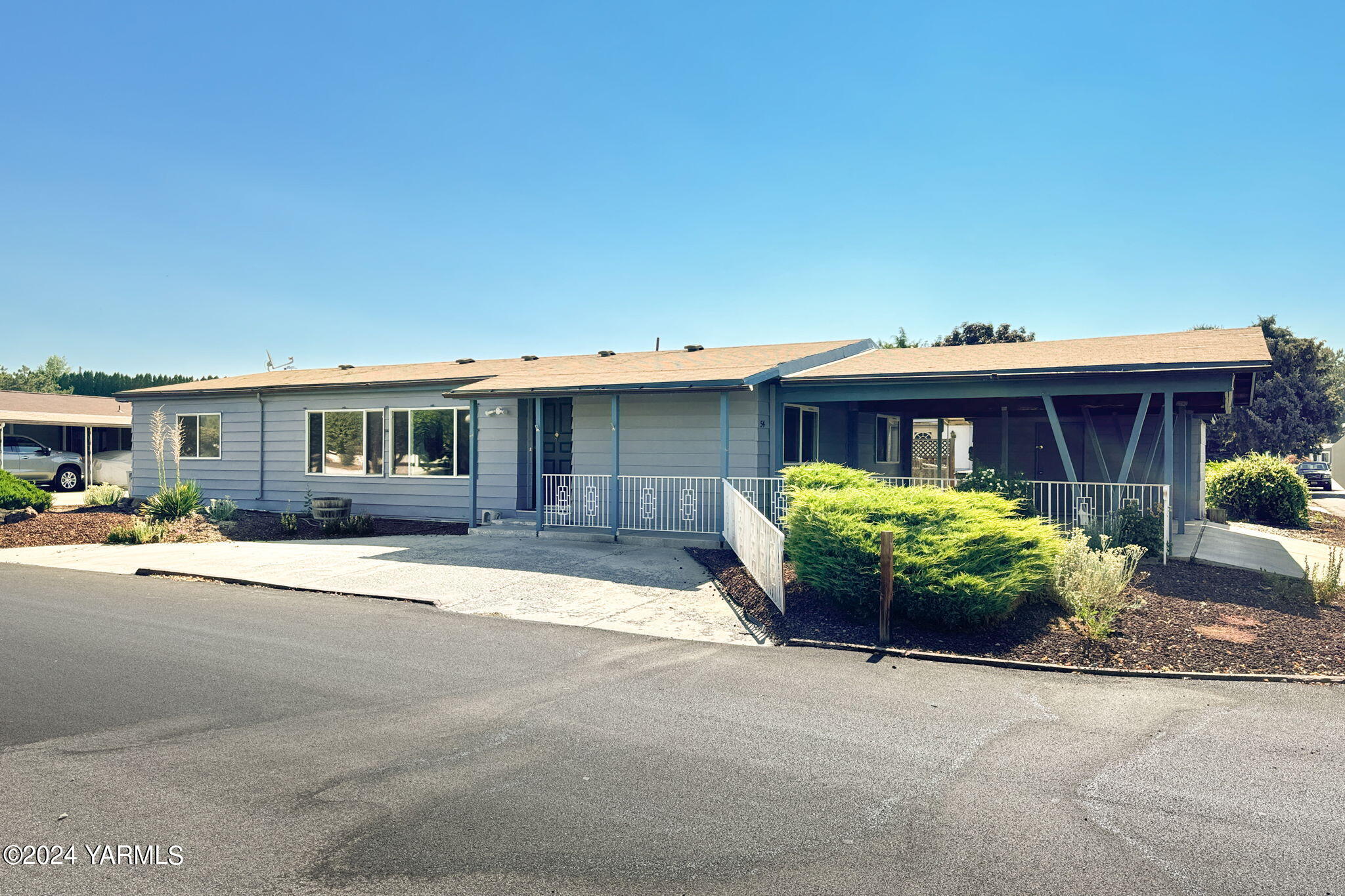 3701 Gun Club Road, Unit 54 Yakima, WA 98901 - Photo 2 of 17 a front view of a house with garden