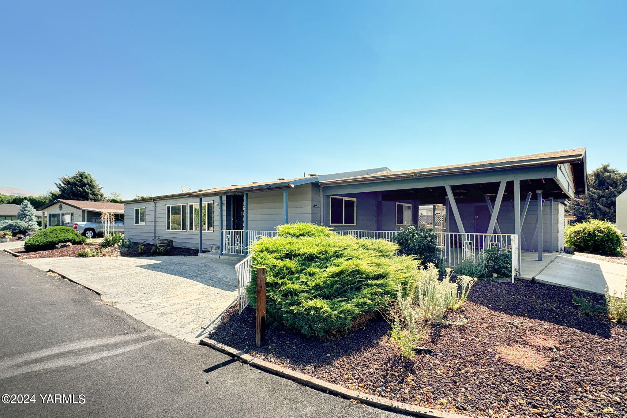 3701 Gun Club Road, Unit 54 Yakima, WA 98901 - Photo 3 of 17 a front view of a house with garden