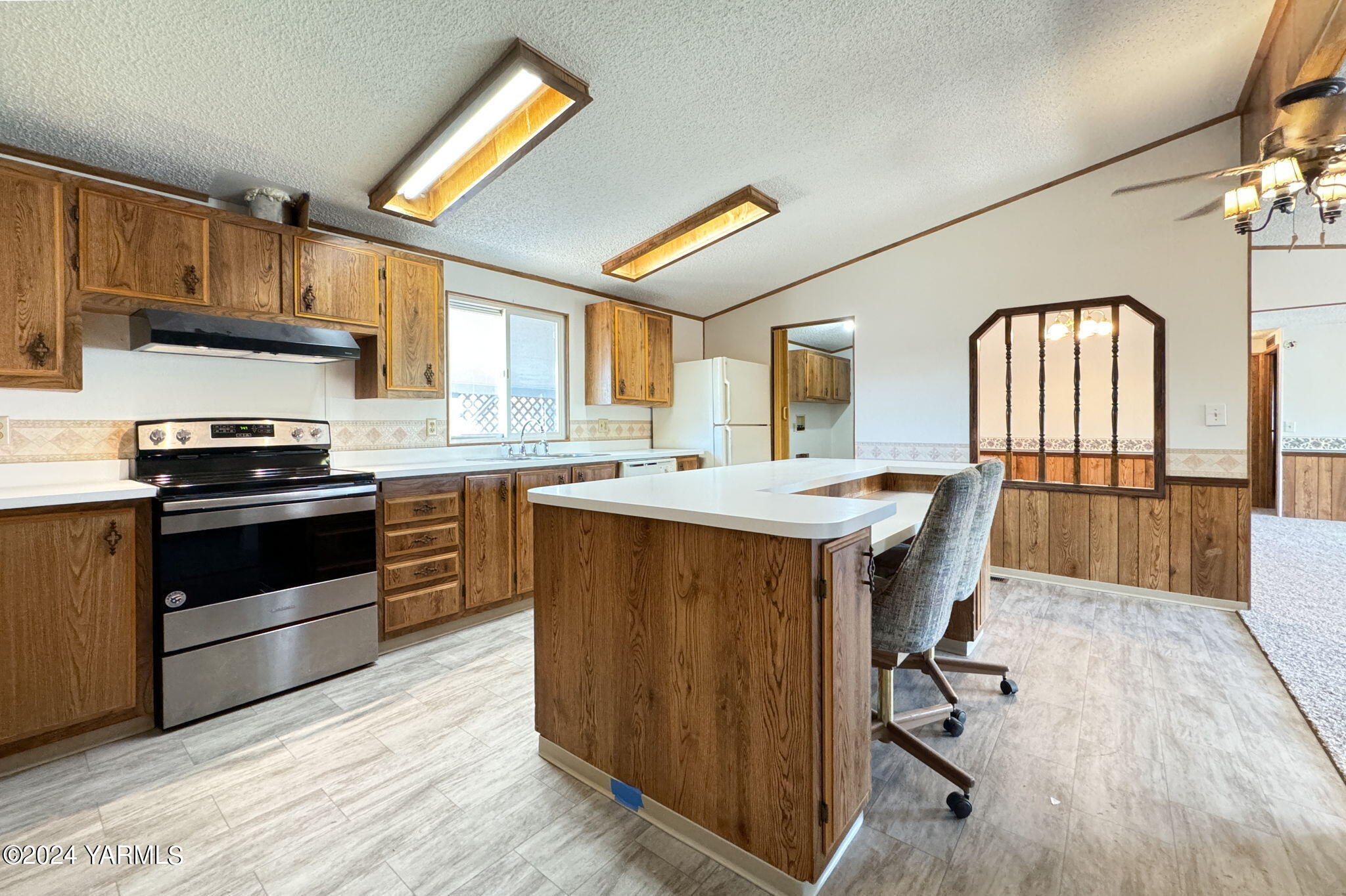 3701 Gun Club Road, Unit 54 Yakima, WA 98901 - Photo 9 of 17 a kitchen with stainless steel appliances a stove a sink dishwasher and cabinets with wooden floor