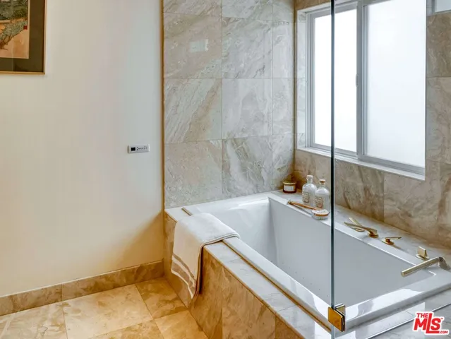 a bathroom with a tub and shower