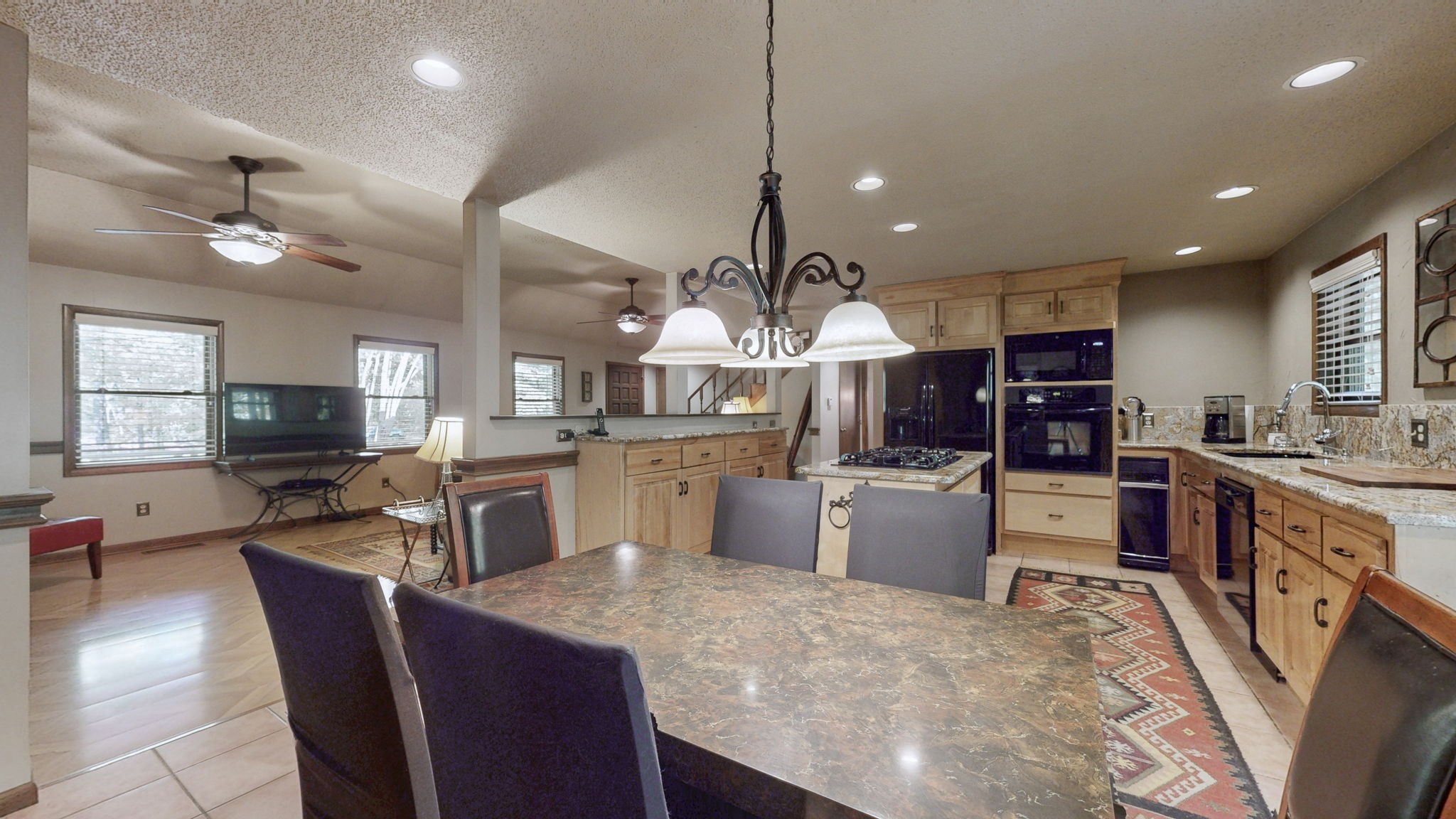 35 Davis Road Springville, TN 38256 - Photo 13 of 50 a kitchen with a table chairs microwave and stove