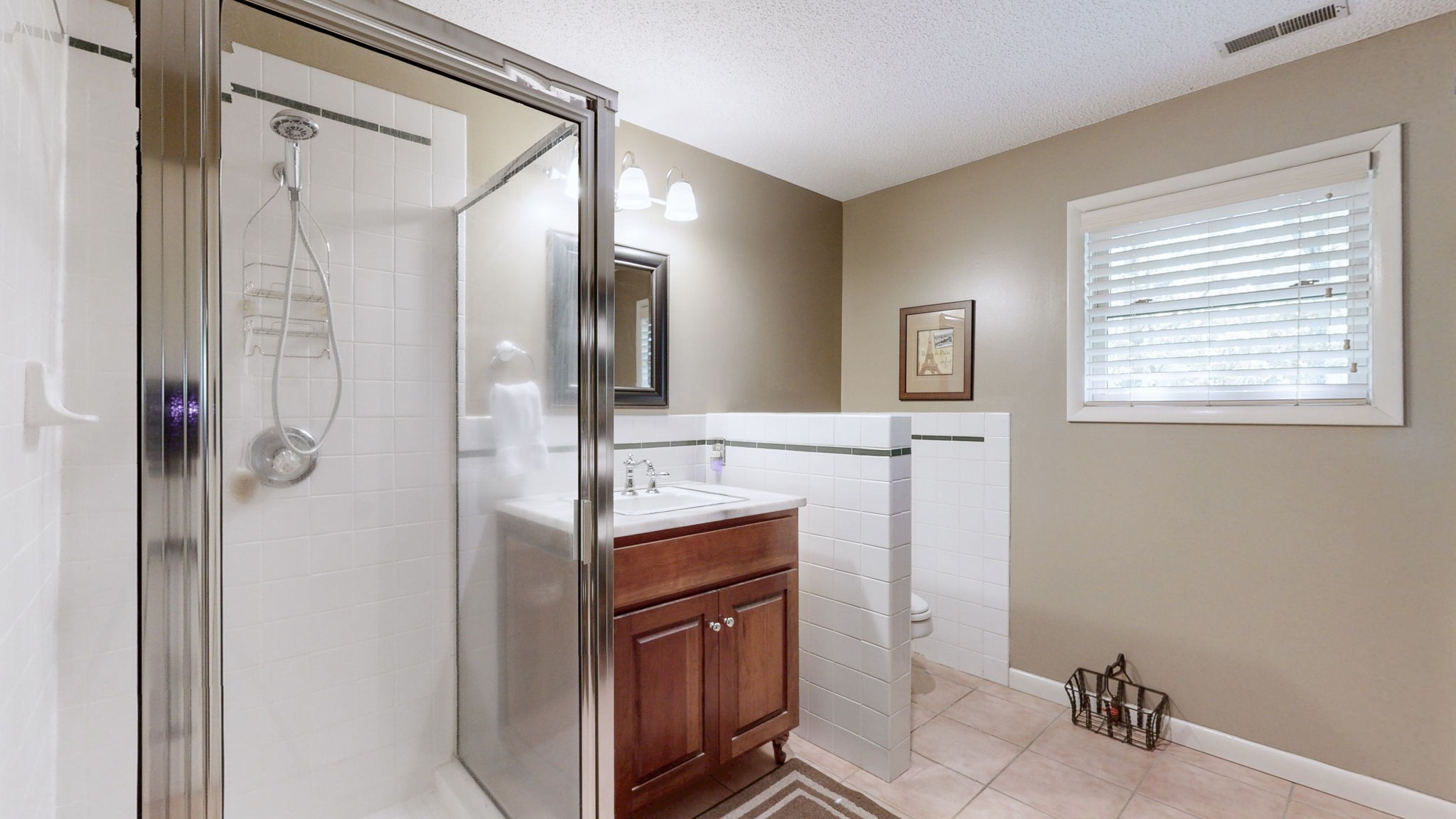 35 Davis Road Springville, TN 38256 - Photo 24 of 50 a bathroom with a granite countertop sink a mirror and shower
