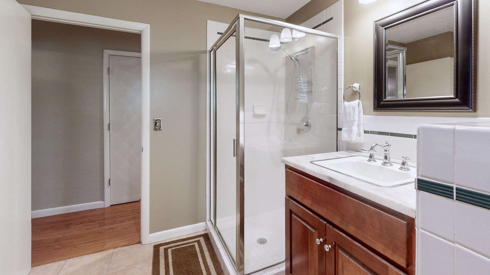 35 Davis Road Springville, TN 38256 - Photo 25 of 50 a bathroom with a sink a mirror a vanity and a shower