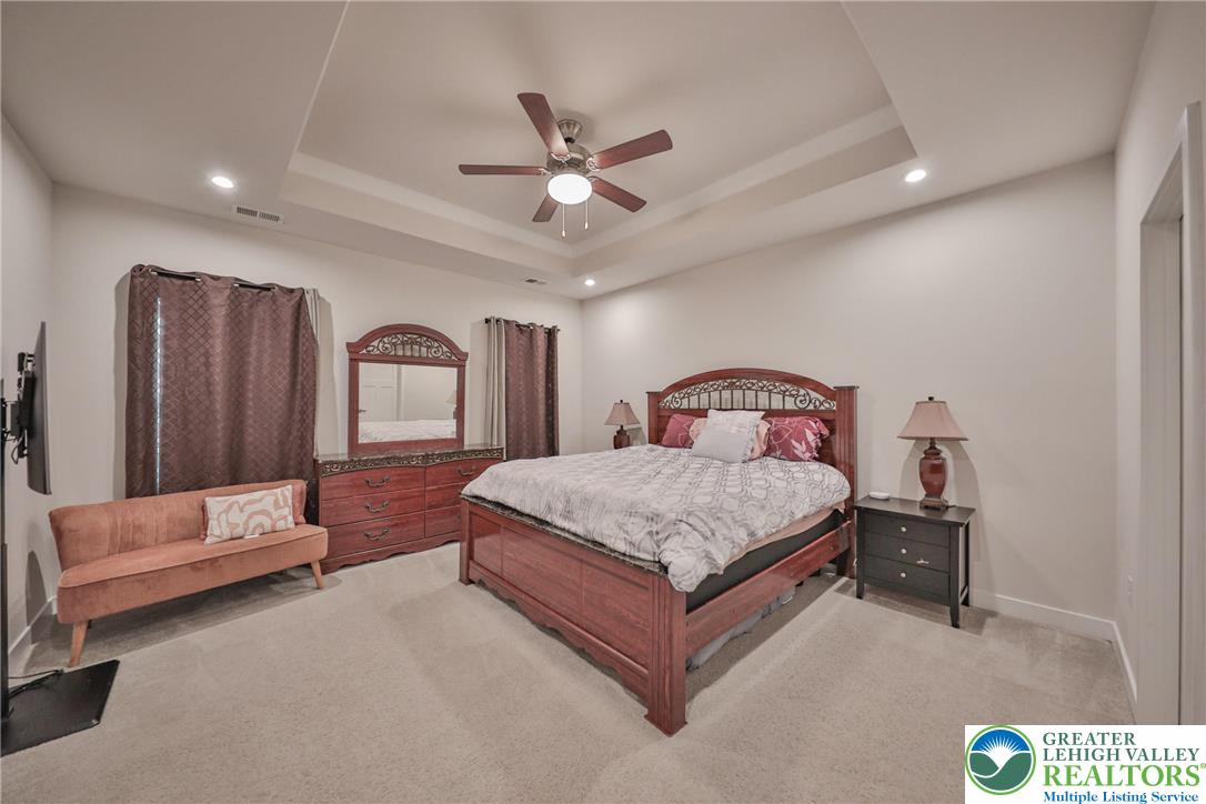 2364 Raya Way Easton, PA 18045 - Photo 15 of 40 a bedroom with a bed and a chandelier