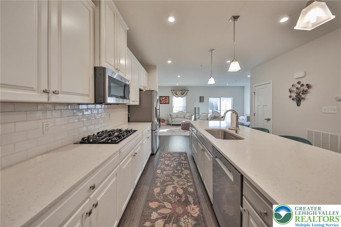 2364 Raya Way Easton, PA 18045 - Photo 9 of 40 a large kitchen with a large counter top a sink a stove and a refrigerator