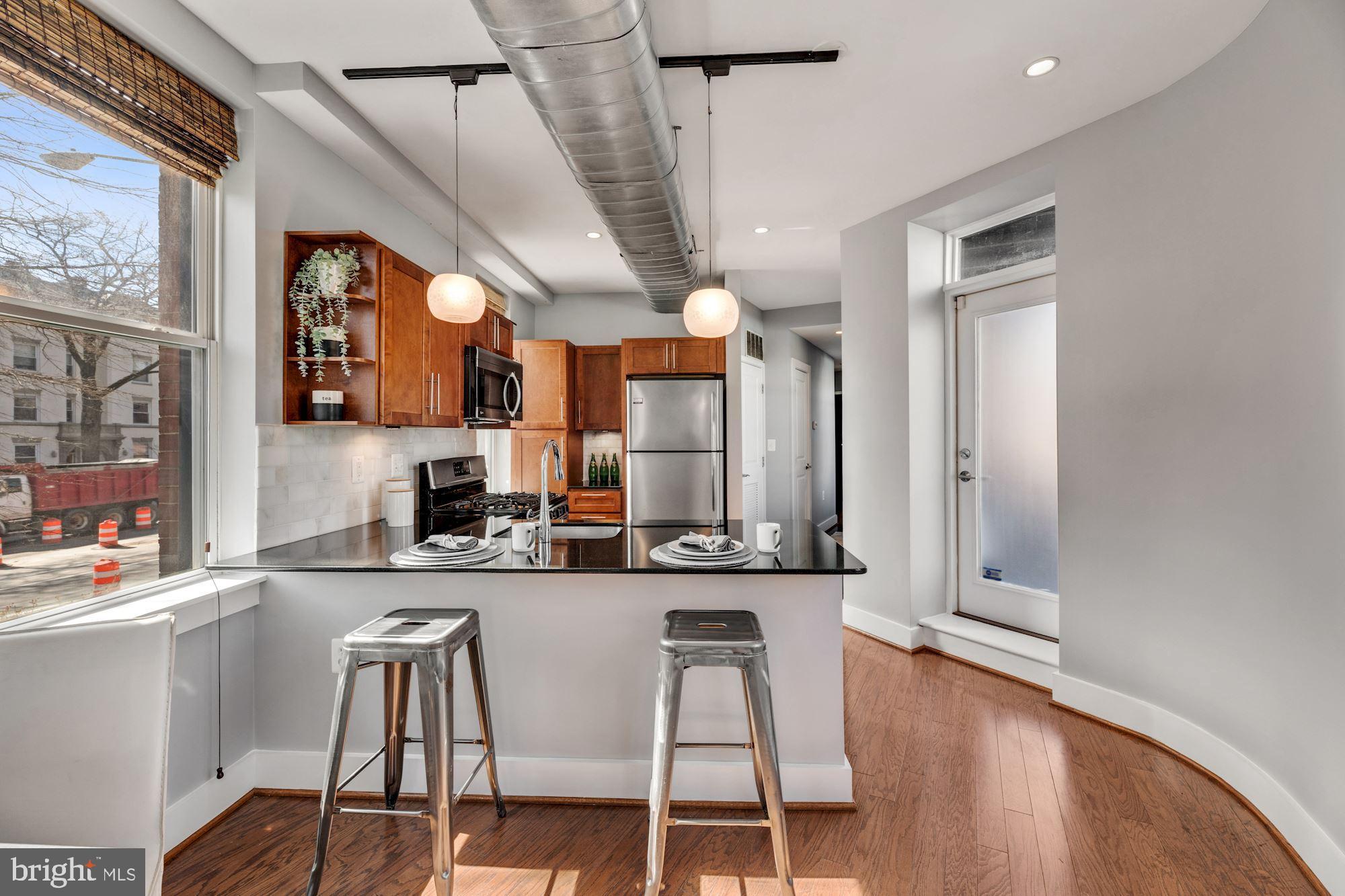 143 Rhode Island Avenue Northwest, Unit 3 Washington, DC 20001 - Photo 1 of 18 a kitchen with stainless steel appliances kitchen island granite countertop a sink and cabinets