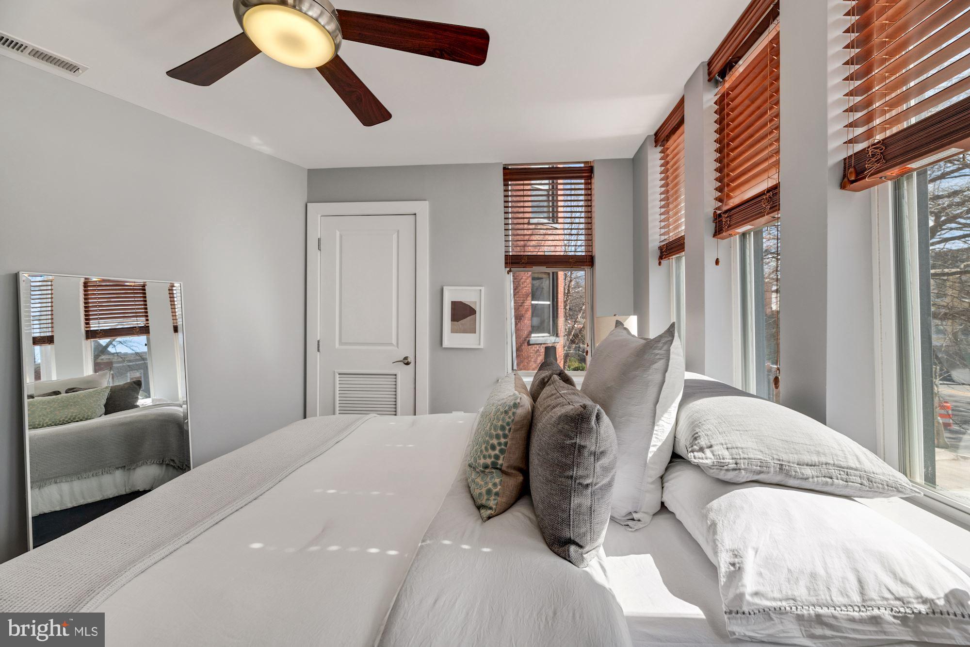 143 Rhode Island Avenue Northwest, Unit 3 Washington, DC 20001 - Photo 12 of 18 a bedroom with a large bed and a chandelier