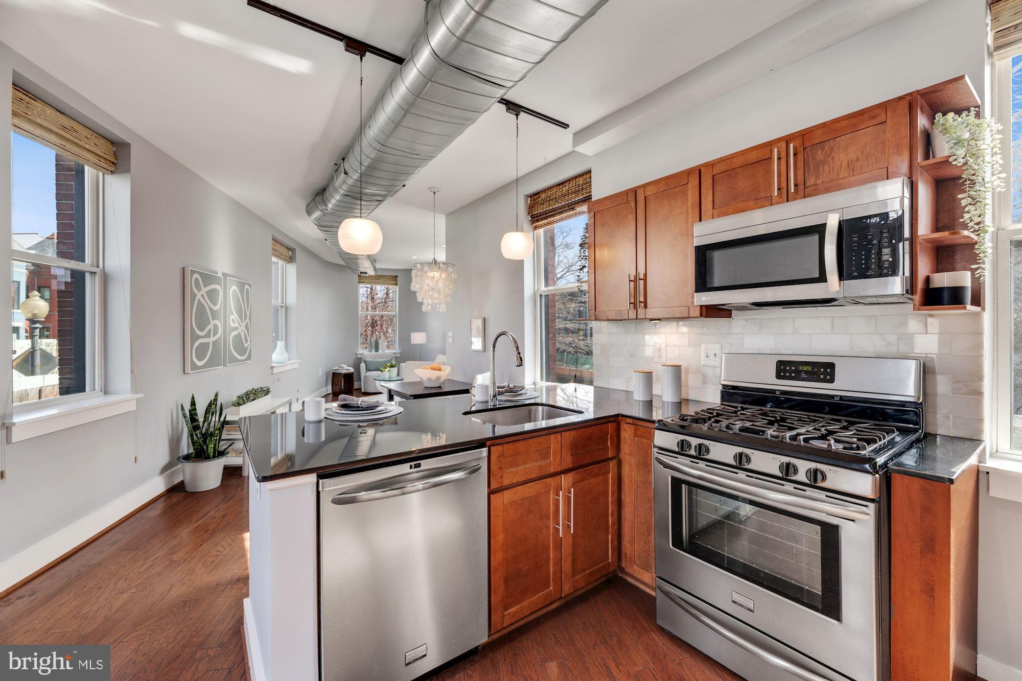 143 Rhode Island Avenue Northwest, Unit 3 Washington, DC 20001 - Photo 3 of 18 a kitchen with stainless steel appliances a stove sink microwave and cabinets