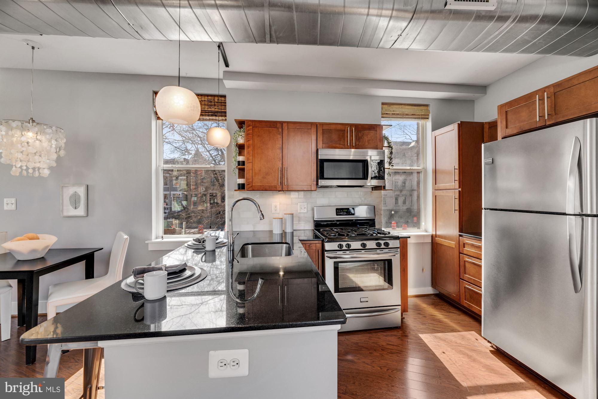 143 Rhode Island Avenue Northwest, Unit 3 Washington, DC 20001 - Photo 4 of 18 a kitchen with kitchen island a stove a sink and a refrigerator