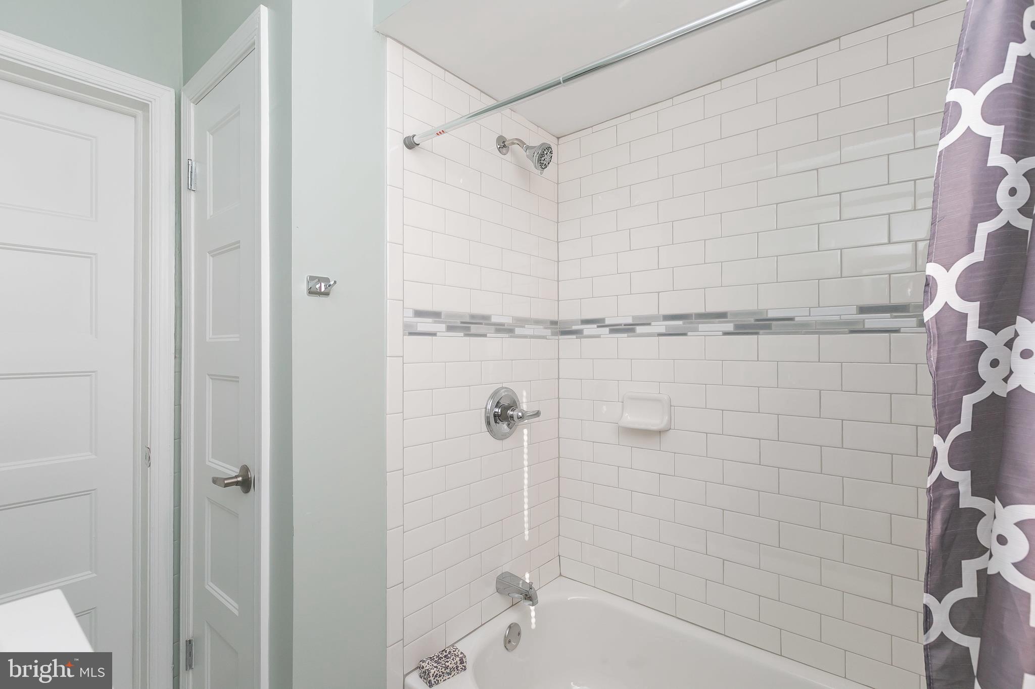 5912 Glenkirk Road Baltimore, MD 21239 - Photo 21 of 32 Upper level bathroom with ceramic tile shower