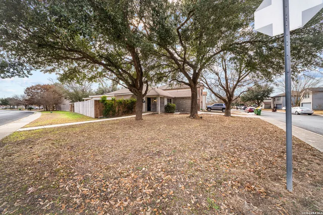 an aerial view of a house with a yard