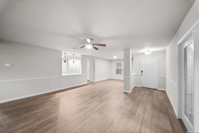 wooden floor in an empty room with a window