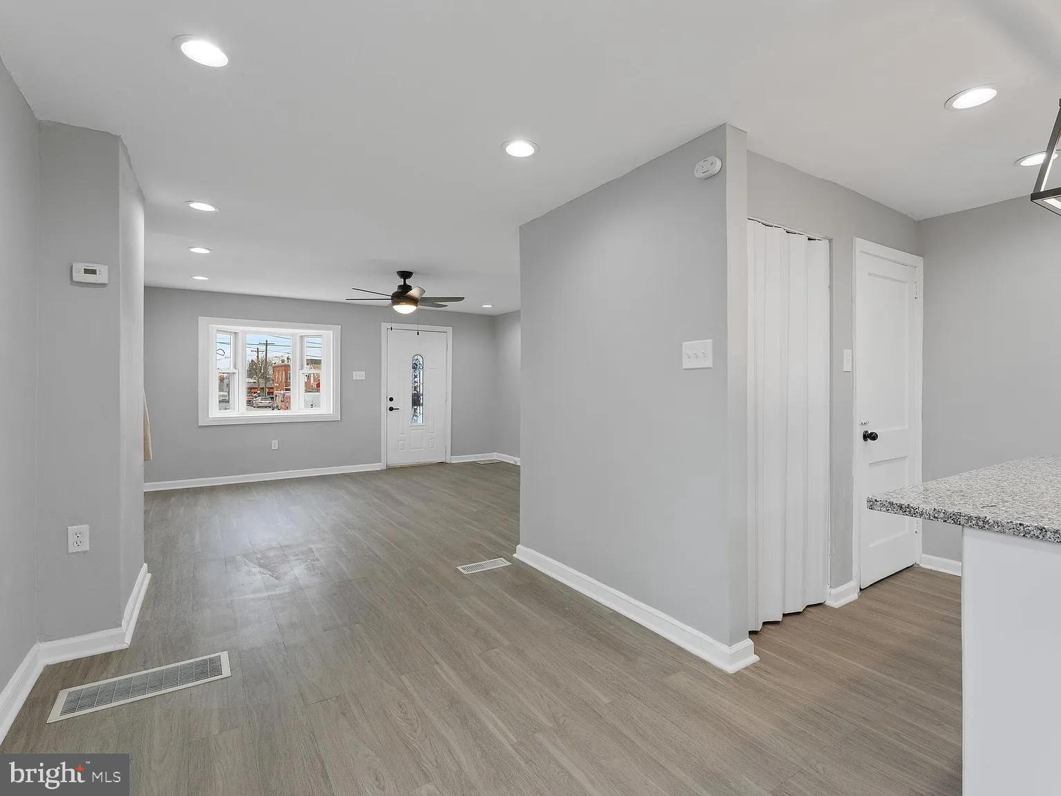 1006 Butler Street Chester, PA 19013 - Photo 14 of 31 an empty room with wooden floor and windows