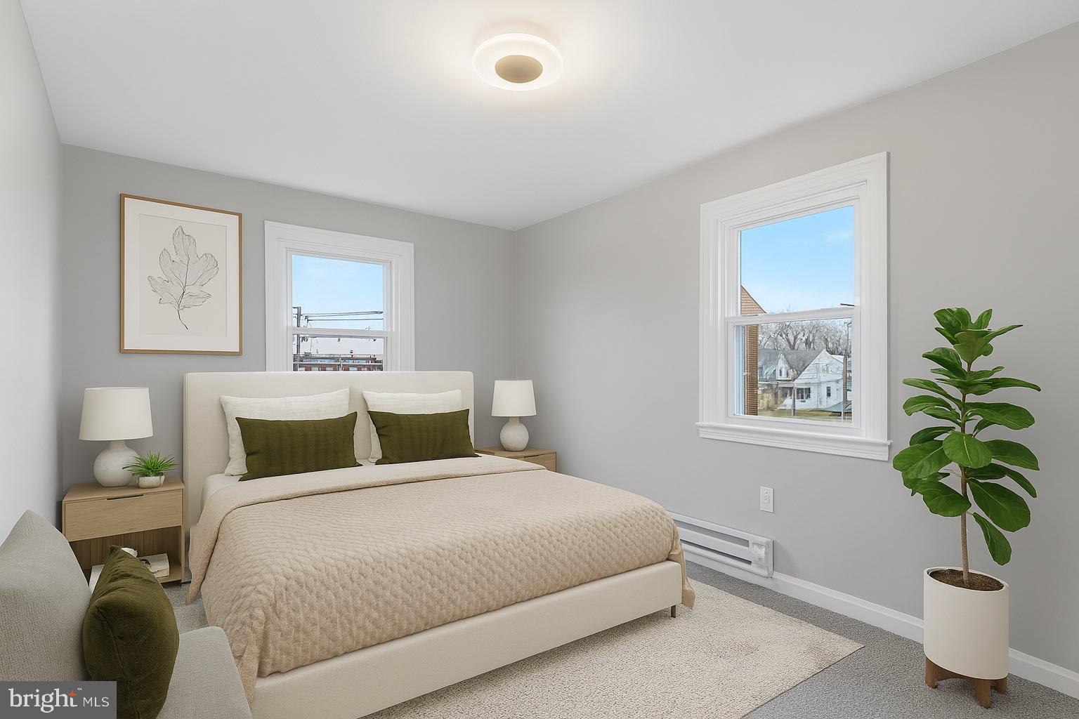 1006 Butler Street Chester, PA 19013 - Photo 17 of 31 a bedroom with a bed and a potted plant