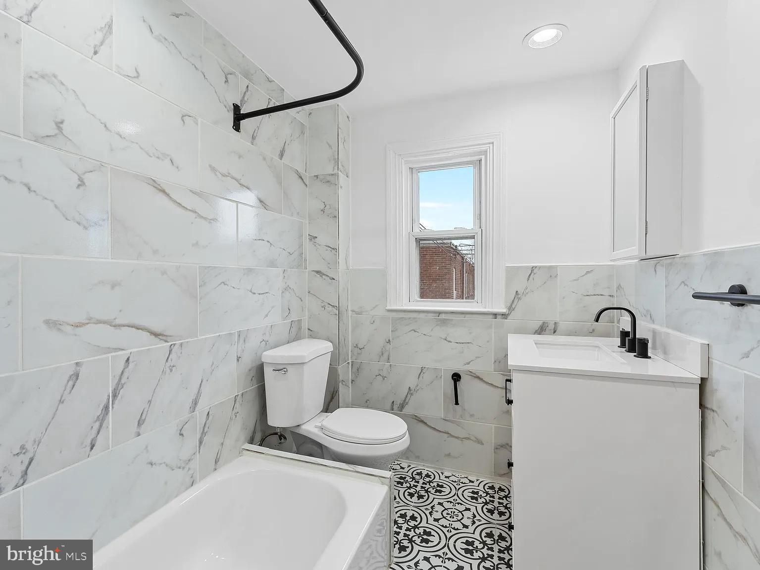 1006 Butler Street Chester, PA 19013 - Photo 19 of 31 a bathroom with a sink a toilet and a mirror