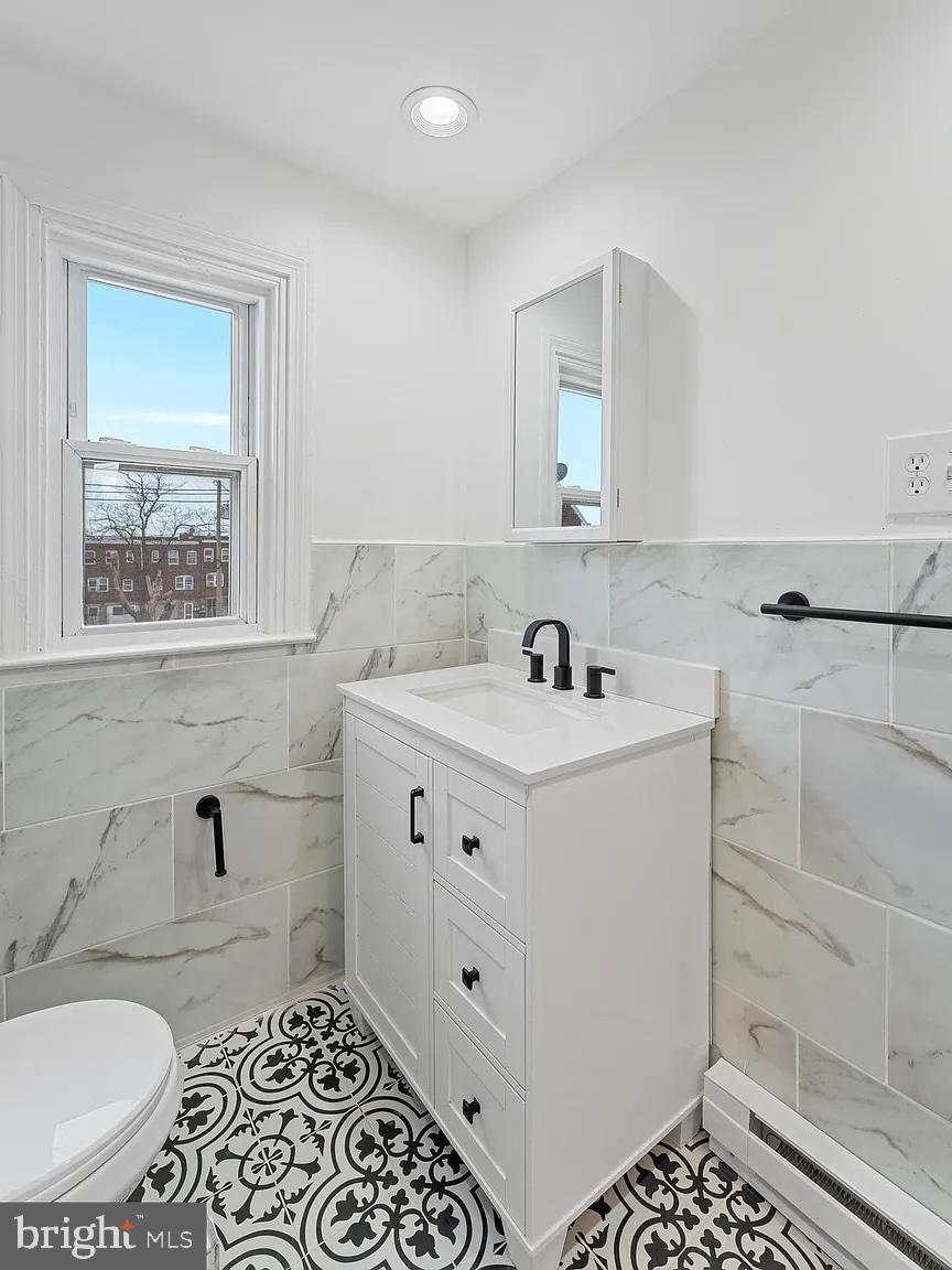 1006 Butler Street Chester, PA 19013 - Photo 20 of 31 a bathroom with a sink a toilet and shower