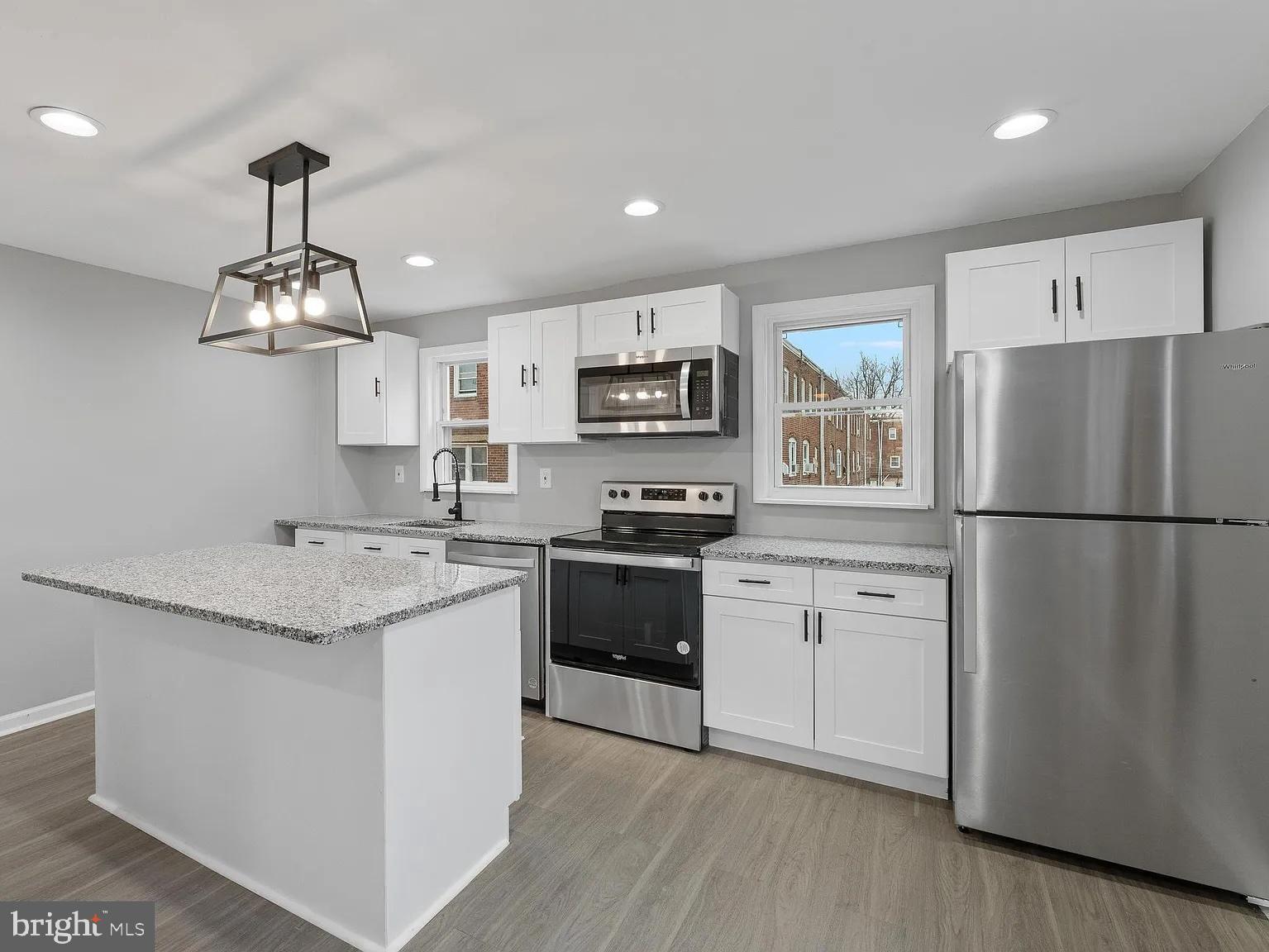 1006 Butler Street Chester, PA 19013 - Photo 2 of 31 a kitchen with stainless steel appliances granite countertop a refrigerator stove a sink and a granite counter tops