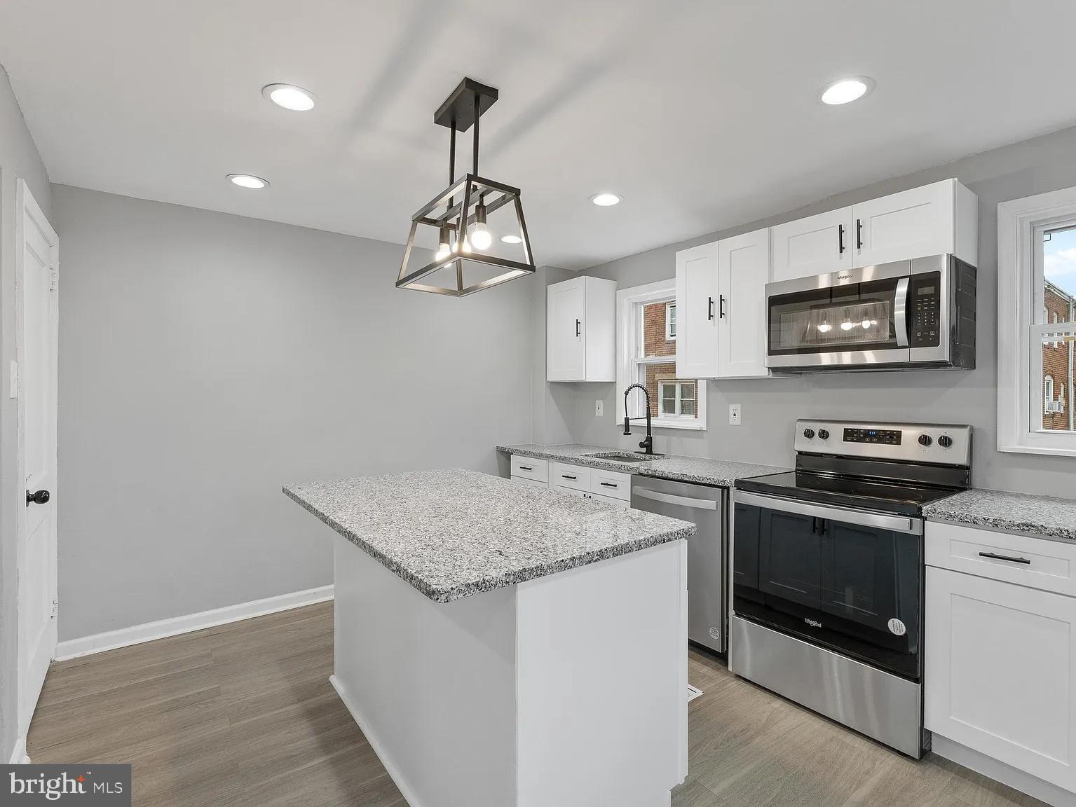 1006 Butler Street Chester, PA 19013 - Photo 3 of 31 a kitchen with stainless steel appliances granite countertop a sink stove and microwave