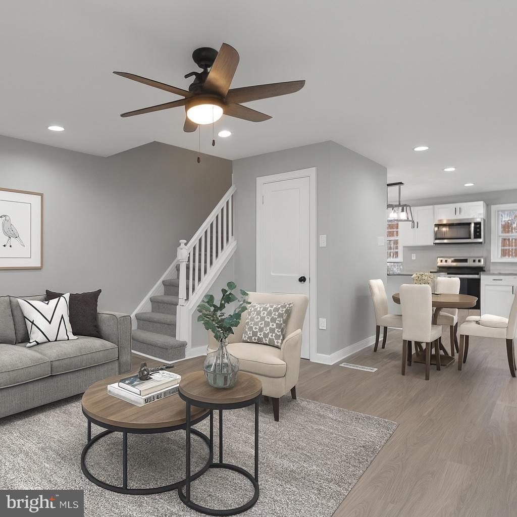 1006 Butler Street Chester, PA 19013 - Photo 9 of 31 a living room with furniture a rug and a chandelier
