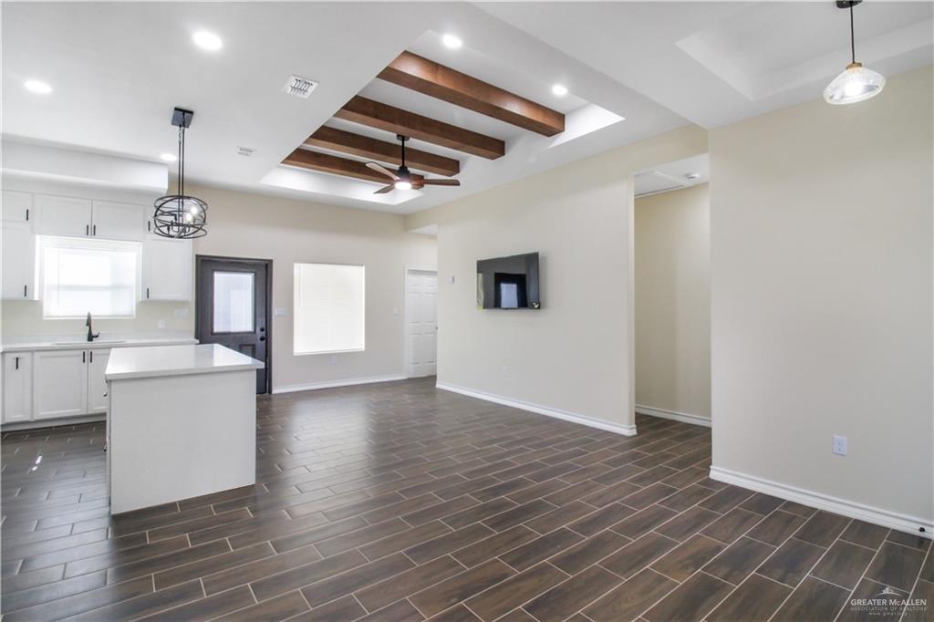 2126 Trinity Street Donna, TX 78537 - Photo 3 of 15 a view of an empty room with a window and wooden floor