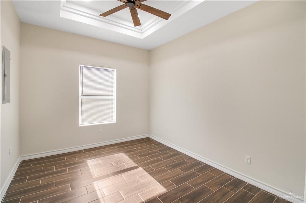 2126 Trinity Street Donna, TX 78537 - Photo 7 of 15 an empty room with a window and ceiling fan