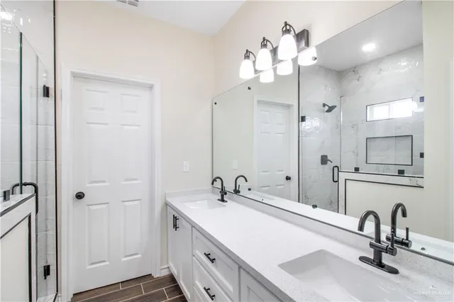 a bathroom with a sink vanity and a mirror