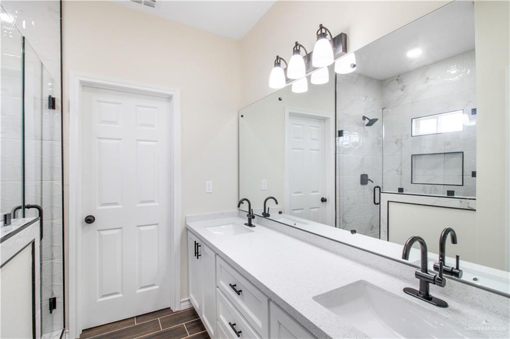 2126 Trinity Street Donna, TX 78537 - Photo 8 of 15 a bathroom with a sink vanity and a mirror