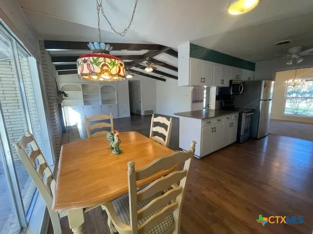 a view of a dining room with furniture wooden floor and a potted plant