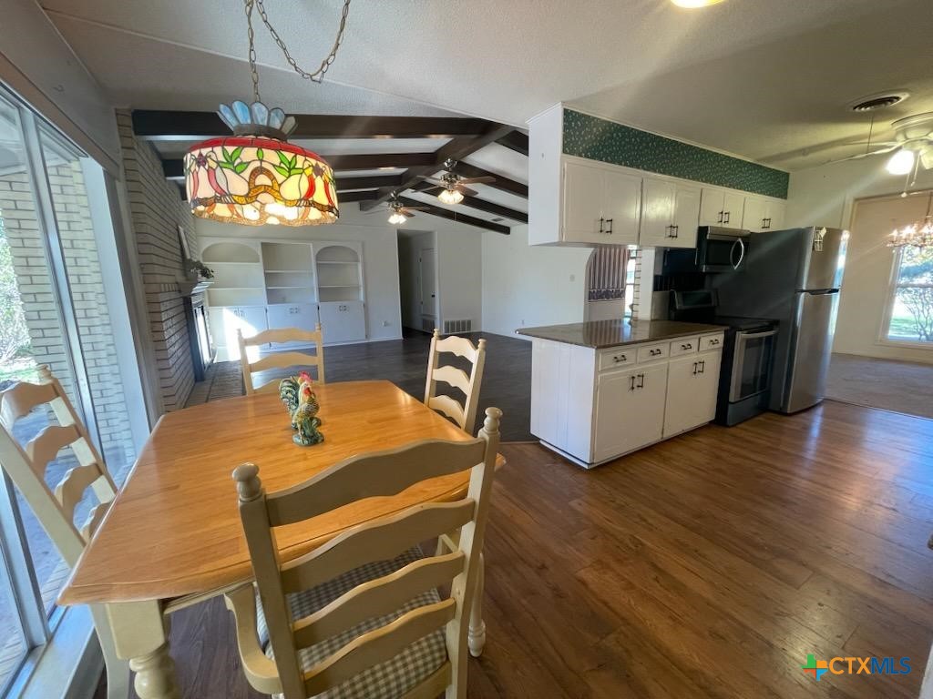 104 Skipcha Trail Lampasas, TX 76550 - Photo 14 of 34 a kitchen with stainless steel appliances kitchen island granite countertop a table chairs and a wooden floor
