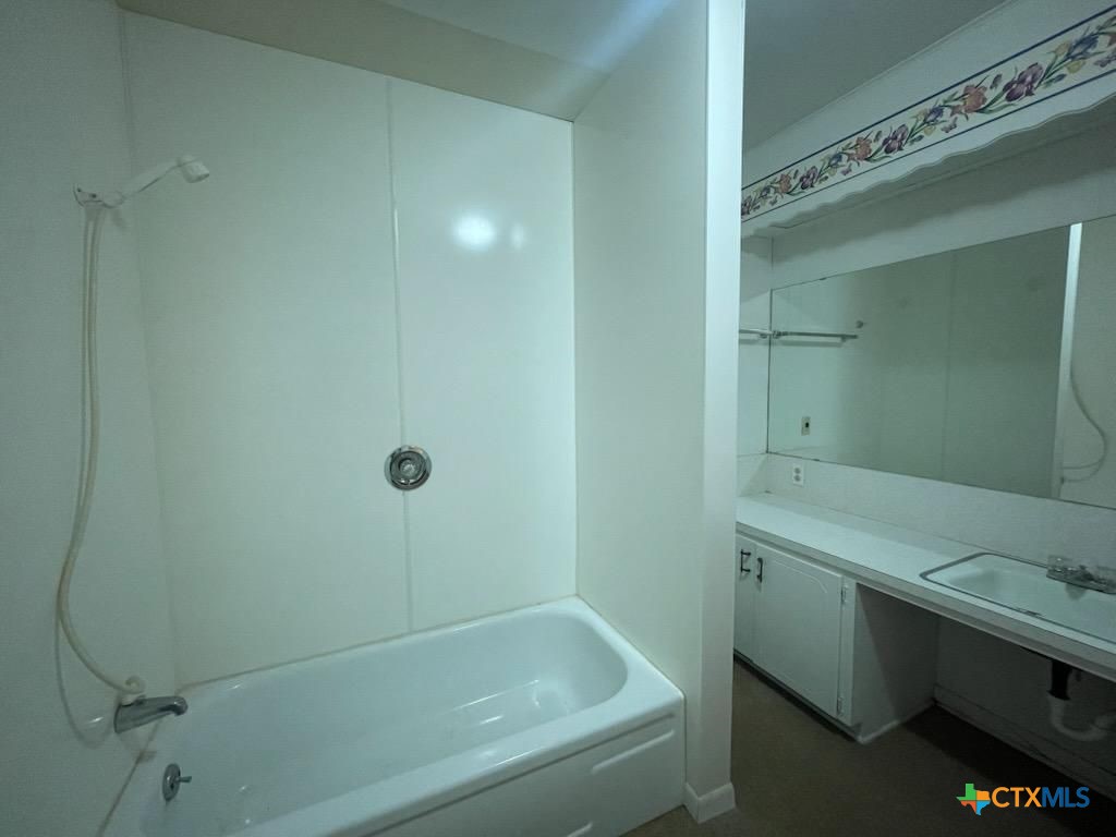 104 Skipcha Trail Lampasas, TX 76550 - Photo 19 of 34 a bathroom with a tub sink and vanity