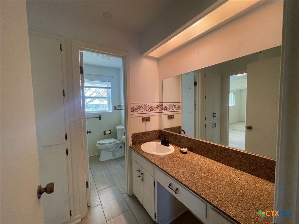 104 Skipcha Trail Lampasas, TX 76550 - Photo 22 of 34 a spacious bathroom with a granite countertop sink and a large mirror