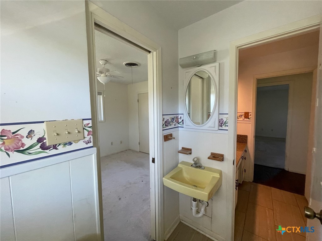 104 Skipcha Trail Lampasas, TX 76550 - Photo 27 of 34 a bathroom with a sink a toilet and a mirror